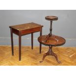 An early 19th century mahogany low tripod table, the circular dished snap top on a baluster