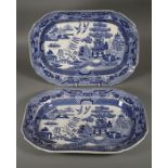 A pair of mid 19th century blue and white pottery meat platters, each printed with Willow pattern,