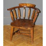 An Edwardian beech and elm Captain's chair with saddle seat, on splayed square legs
