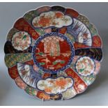 A 19th century Japanese porcelain charger of lobed form typically decorated in the Imari pallette