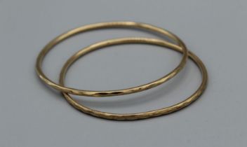 A pair of 9ct diamond cut bangles, weight approximately 10.7gm, both hallmarked 9ct