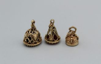 Three ornate 9ct fob seals, two set with carnelian, the third set with blackish-blue hardstone,