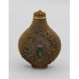 Chinese snuff bottle. Gilt damascene filigree of flattened bladder shape on a small oval foot,