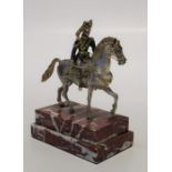 A cast white and gilt metal figure of an Hussar's Officer on horseback. Stepped rectangular veined