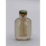 Chinese snuff bottle. Glass of clear monolithic material, of flattened flask form on a broad