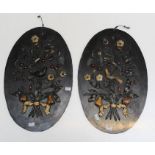 A pair of 19th century oval slate wall plaques, each decorated in relief with applied polished
