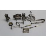 A small quantity of decorative silver and silver mounted items comprising a small toast rack, a pair
