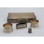 A selection of silver comprising a silver thimble, marked for Chester, two napkin rings (