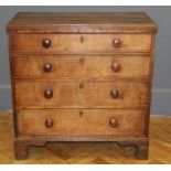 A George III oak chest of drawers having two short and three long drawers with knob handles,