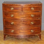 An early 19th century mahogany chest of bow front form, the ebony and satinwood strung top over