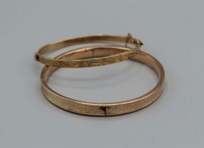 A pair of engraved bangles,, one hallmarked hinge bangle with safety chain, approximate weight 12.