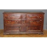 A George III mahogany low dresser, the rectangular top above an arrangement of two short and four