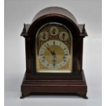 A late 19th century German mahogany director's clock, the dome case with brass flame finials,