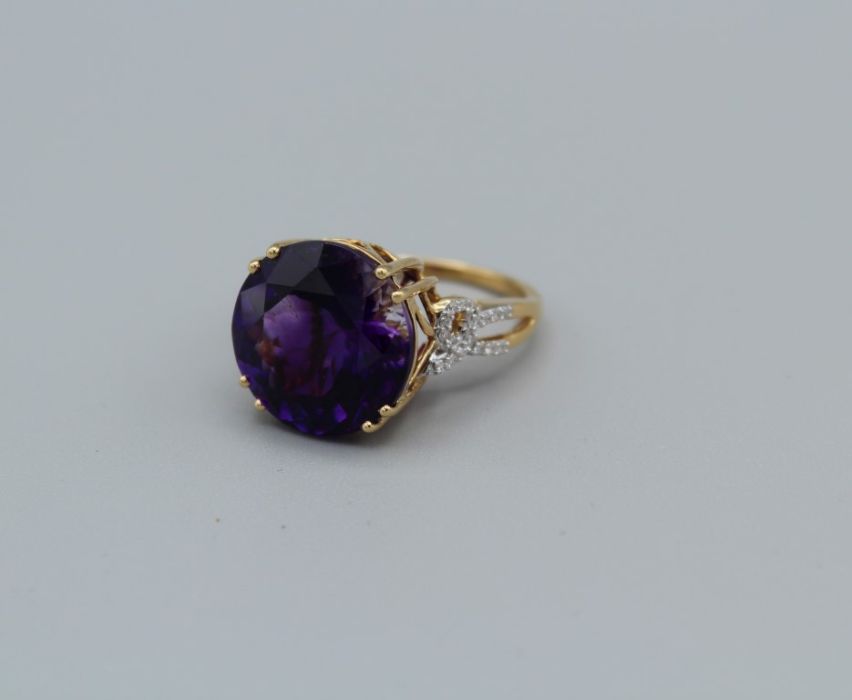 An 18k Gemporia amethyst and diamond ring, the round amethyst of 11.35ct, with diamond set pierced