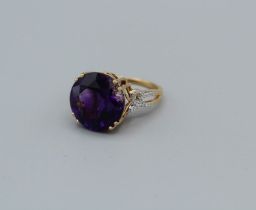 An 18k Gemporia amethyst and diamond ring, the round amethyst of 11.35ct, with diamond set pierced