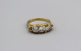 A three stone old European cut diamond dress ring, the central stone with an approximate diameter of