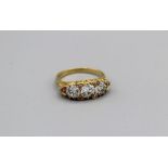 A three stone old European cut diamond dress ring, the central stone with an approximate diameter of