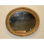 A large 19th century gilt gesso oval portrait picture frame with moulded floral decoration,