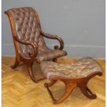 An early 20th century buttoned and close studded chocolate hide upholstered open armchair with