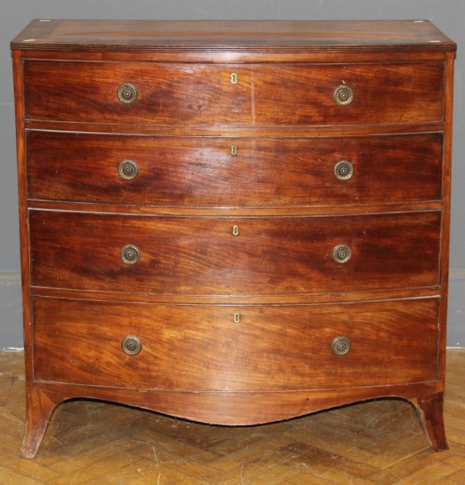 An early 19th century mahogany chest of bow front form, the crossbanded top over four graduated long