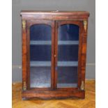 A Victorian walnut veneered dwarf cabinet enclosed by a pair of glazed panel doors