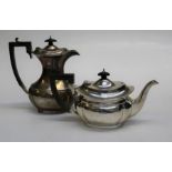 W and G, a George V silver teapot of paneled oval form with ebonized fittings, Sheffield 1923