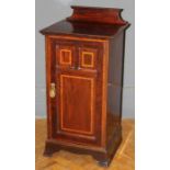 An Edwardian mahogany, satinwood banded pot cupboard, with shaped upstand and three panel door