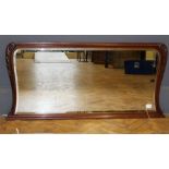 A mahogany overmantel mirror, the oblong plate enclosed by a moulded and scroll carved frame,