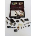 An Edwardian leather writing case containing various collector's items, including pin cushions,