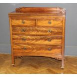 An Edwardian mahogany chest, the oblong top over two short drawers with brass ring handles, raised