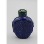 Chinese snuff bottle. Lapis lazuli of shield shape on a raised foot, with tao tie mask and ring