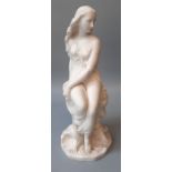 Minton, a 19th century parian figure of Miranda, seated upon a rock with shell and waves at her