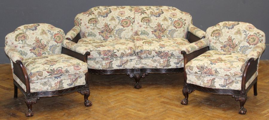 A Victorian mahogany drawing room suite, comprising a two person settee and pair of armchairs,