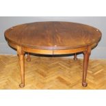 A late 19th century mahogany, winding extending dining table, the oval top and two inset leaves with