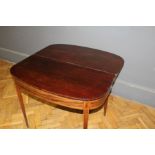 An early 19th century mahogany supper table, D shape reeded fold over top above satinwood and