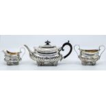 A Victorian silver three piece tea set comprising teapot, sugar bowl and milk jug, Georgian style