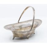 A Georgian style silver reticulated oval basket, swing handle, on four scroll feet, hallmarked by
