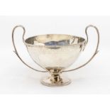 A George V silver two handled presentation cup, loop handles, facet body on spreading circular foot,