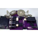 A collection of silver lidded, topped or handled vanity items to include: a cased part-set including