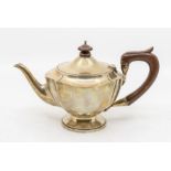 A George V silver teapot, fruitwood finial and handle, hallmarked by Henry Matthews, Birmingham,