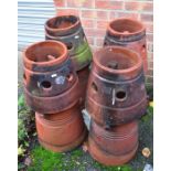 A group of four matching terracotta chimney pots