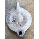 Late Roman North African Grave Offering decorated oil lamp. Approximately 9cm long and 3.5cm high.