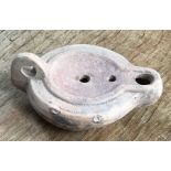 Late Roman North African Grave Offering oil lamp. Approximately 10cm long and 4cm high.
