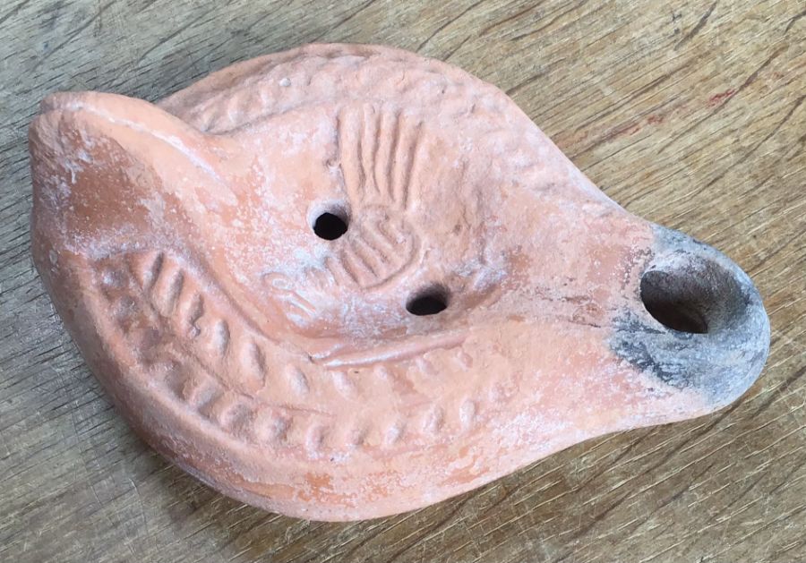 Late Roman North African Grave Offering Decorated Samian oil lamp. Approximately 13cm long and 5cm