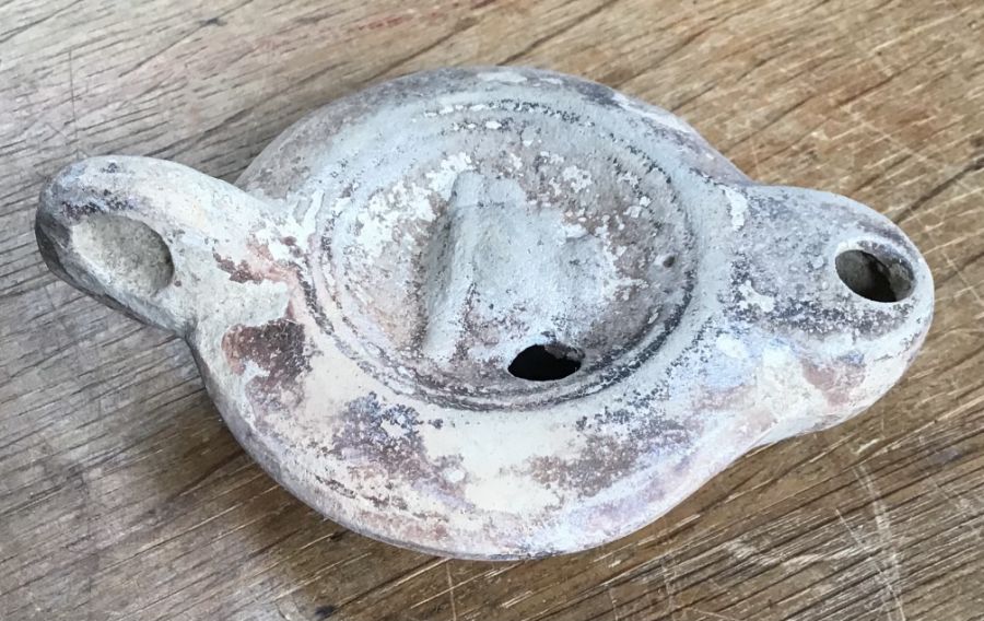 Late Roman North African Grave Offering decorated oil lamp. Approximately 11cm long and 5cm high.