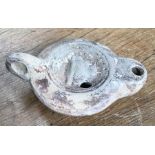 Late Roman North African Grave Offering decorated oil lamp. Approximately 11cm long and 5cm high.