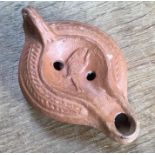Late Roman North African Grave Offering Decorated Samian oil lamp. Approximately 12cm long and 5cm
