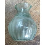 Rare unbroken Roman glass funeral offering vase, North African. Approximately 8cm high, 5.5cm wide.