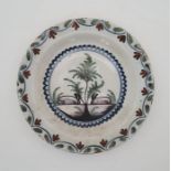 An early 18th century Lambeth Delftware plate, painted in colours, N.C.S. Exhibition Leeds 1974