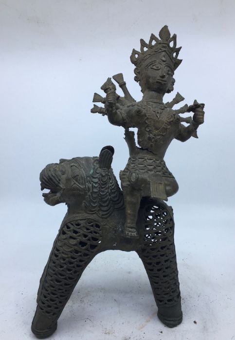 A 20th century Indian bronze figure of a deity upon a lion, height 33cm.
